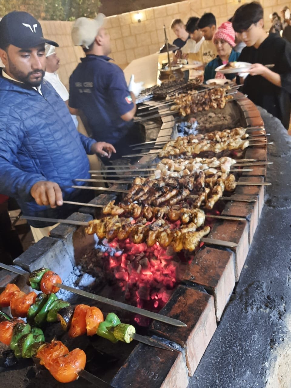 BBQ dinner buffet at desert safari camp at night